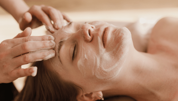 Woman getting her face cleansed during a classic facial.